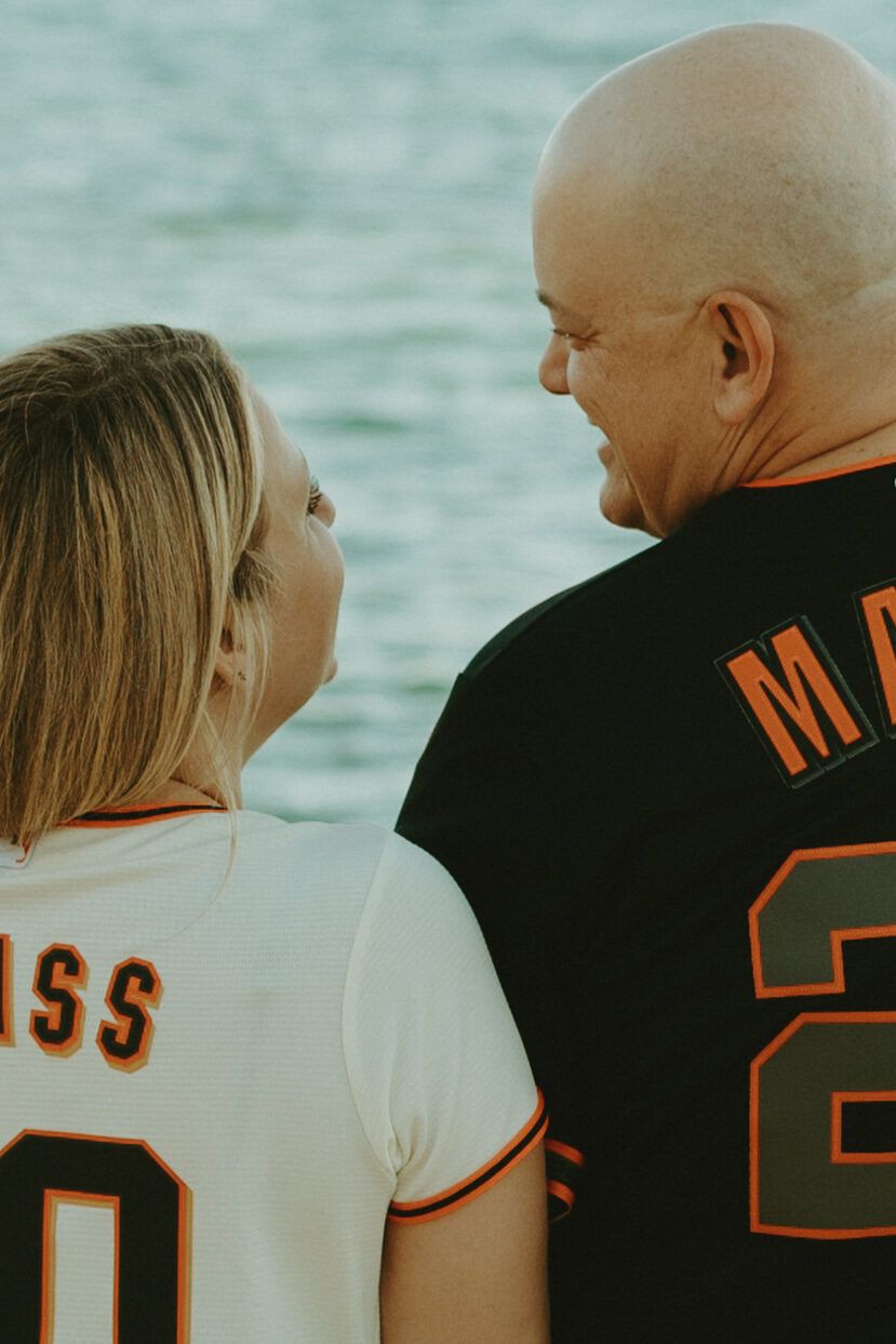 Glancing back over their shoulders, laughing, in Giants jerseys