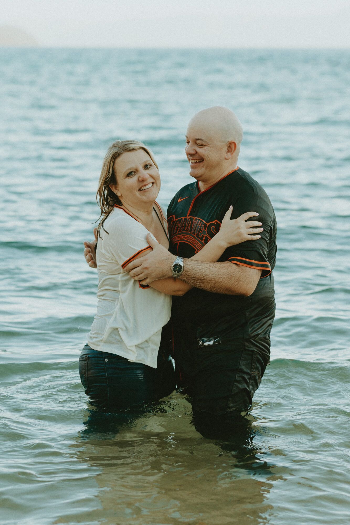 An embrace in the lake, both glowing with joy